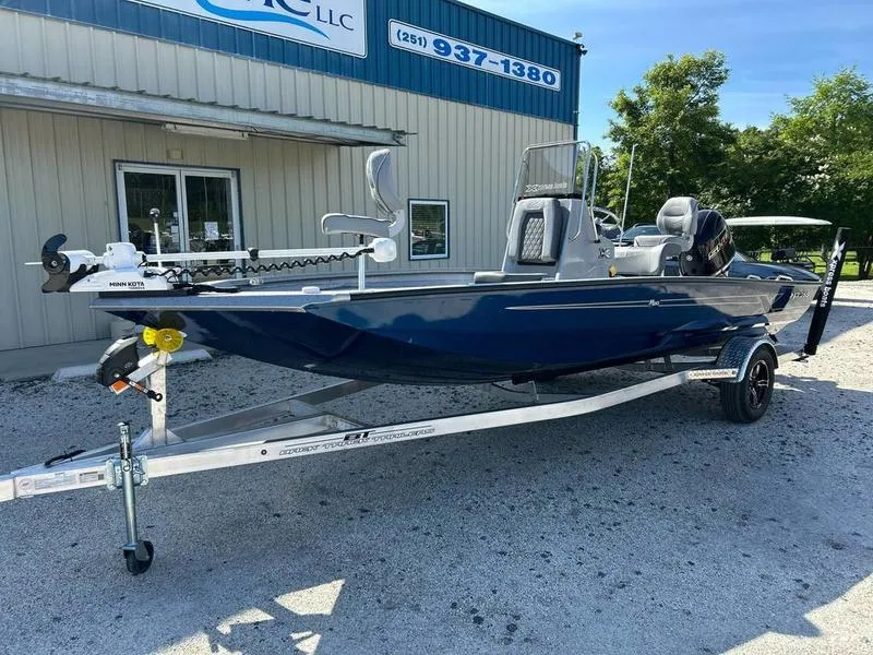 Slide: The Image of 2025 Xpress H20B boat on trailer outside dealership, featuring sleek design and modern equipment. - 15