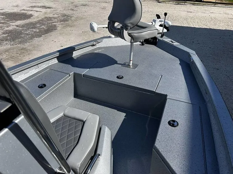 Slide: The Image of 2025 Xpress H20B boat interior with gray seating and deck, featuring a mounted chair. - 17