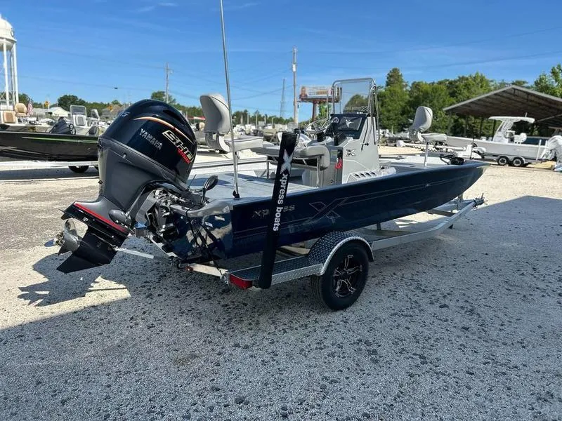 Slide: The Image of 2025 Xpress H20B boat with Yamaha engine on trailer in outdoor setting. - 2