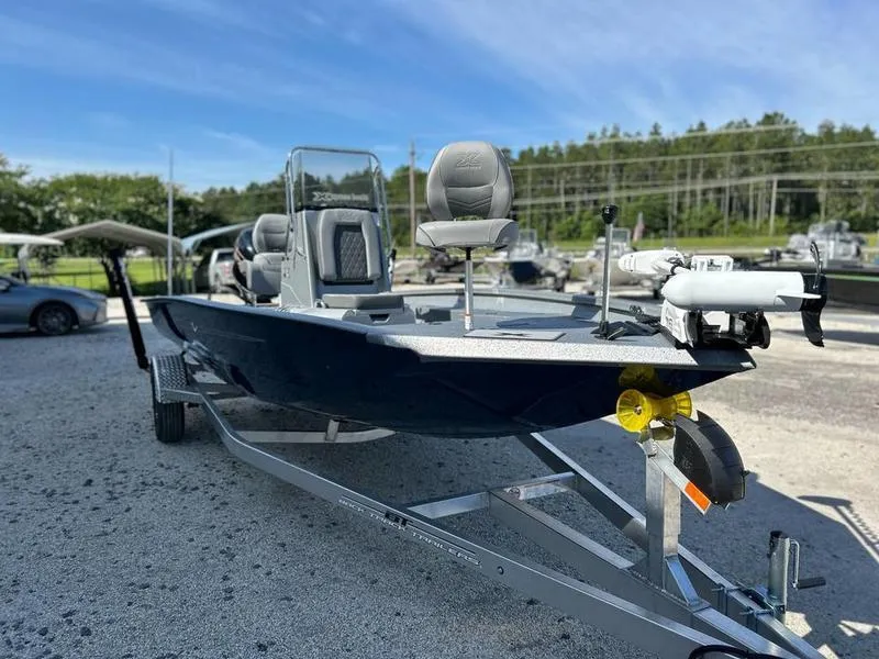 Slide: The Image of 2025 Xpress H20B boat on trailer, parked outdoors, clear sky background. - 3