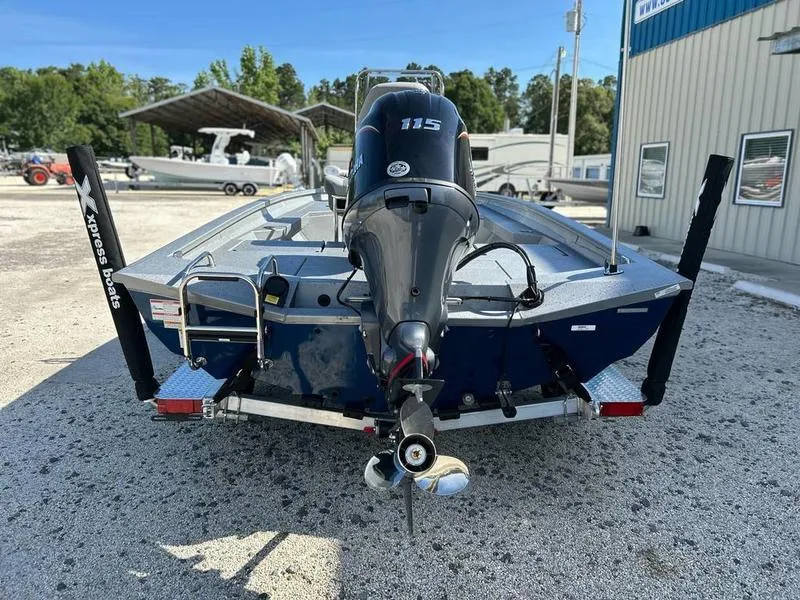 Slide: The Image of 2025 Xpress H20B boat with Yamaha 115 engine, parked outdoors. - 4