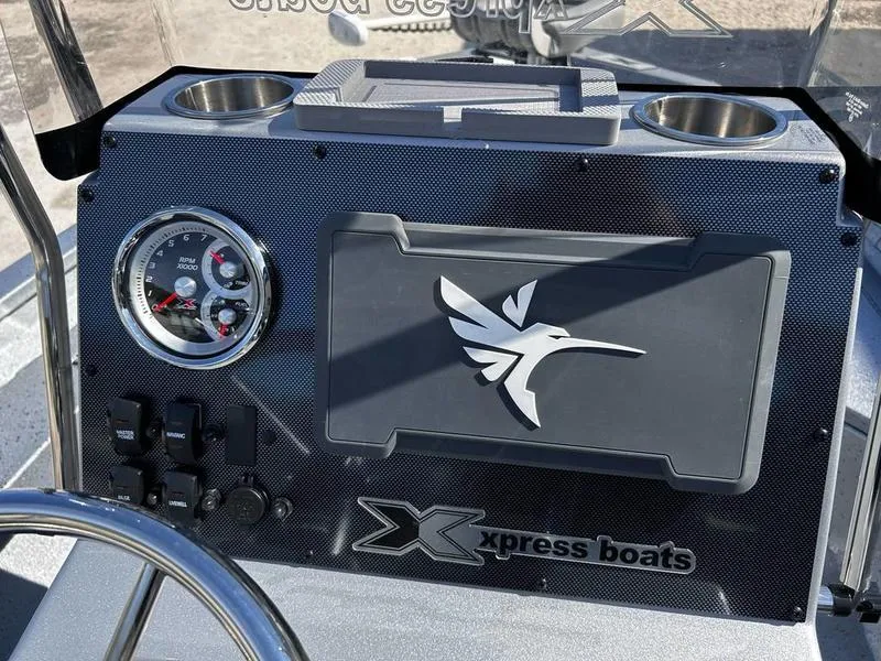 Slide: The Image of 2025 Xpress H20B boat dashboard with logo and gauges. - 9