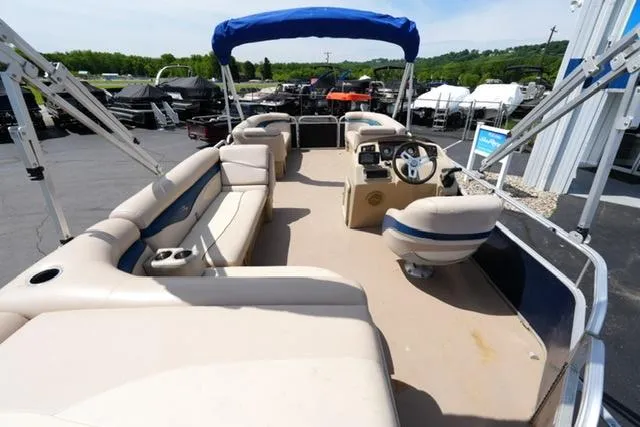 Slide: The Image of 2012 Bennington 24 SLX pontoon boat with spacious seating and blue canopy. - 12