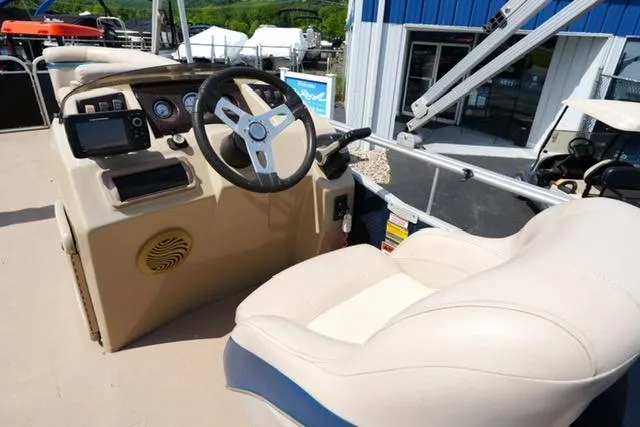 Slide: The Image of 2012 Bennington 24 SLX boat helm with steering wheel and beige captain's chair. - 9