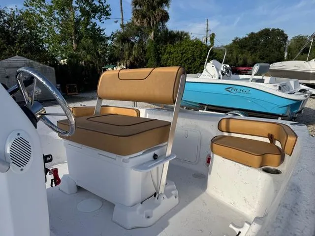 Slide: The Image of Modern ALK2 18CRS GPS boat interior with tan seating, steering wheel, and stereo system, 2025 model. - 3