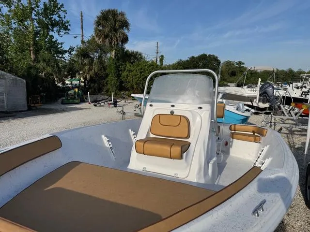 Slide: The Image of 2025 ALK2 18CRS GPS boat with tan seating, parked outdoors. - 4