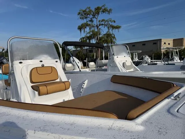 Slide: The Image of 2025 ALK2 18CRS GPS - STEREO boat with tan seating, docked outdoors. - 5