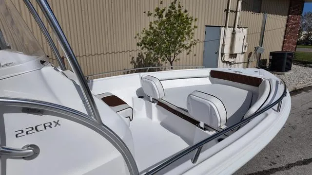 Slide: The Image of 2025 ALK2 22CRX boat with white seating and sleek design, parked outdoors. - 10
