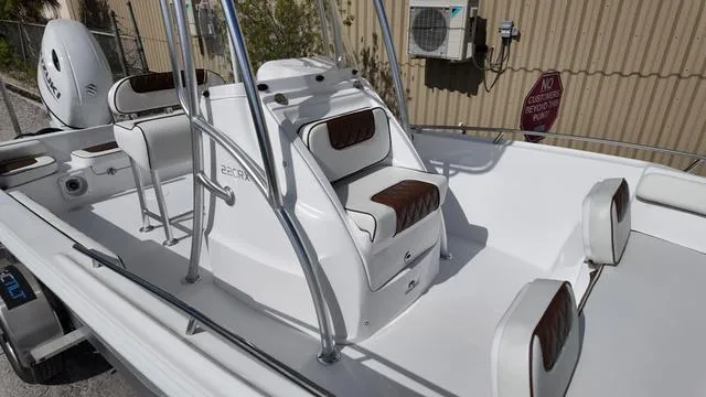 Slide: The Image of 2025 ALK2 22CRX boat interior with white and brown seating, sleek design. - 12