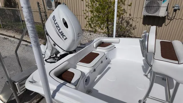 Slide: The Image of Boat interior with Suzuki engine, ALK2 22CRX model, 2025, featuring cushioned seating and storage. - 14