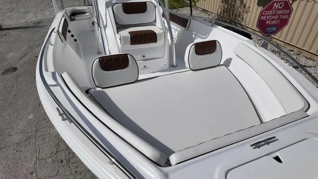 Slide: The Image of 2025 ALK2 22CRX boat interior with white cushioned seating and brown accents. - 17