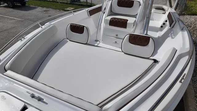 Slide: The Image of 2025 ALK2 22CRX boat interior with white and brown cushioned seating. - 18
