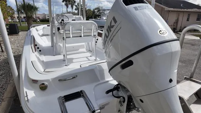 Slide: The Image of 2025 ALK2 22CRX boat with Suzuki outboard motor, docked in a sunny marina. - 21