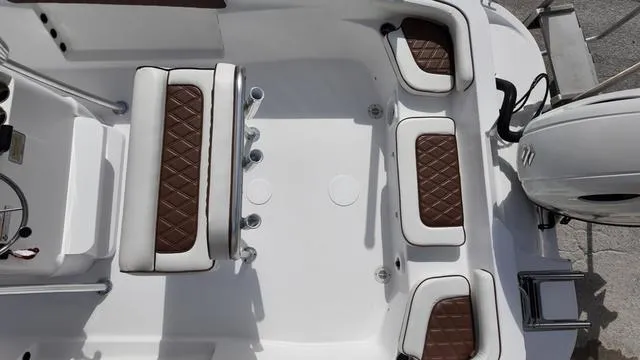 Slide: The Image of 2025 ALK2 22CRX boat interior with brown diamond-stitched seating and modern design. - 23