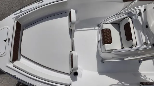 Slide: The Image of Luxurious seating on 2025 ALK2 22CRX boat, featuring white and brown cushioned design. - 24
