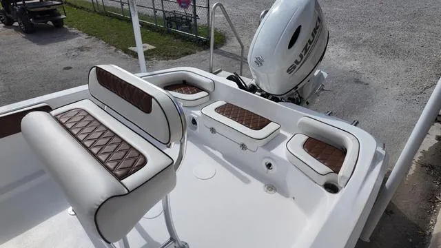 Slide: The Image of 2025 ALK2 22CRX boat interior with brown and white seating, Suzuki outboard motor. - 4