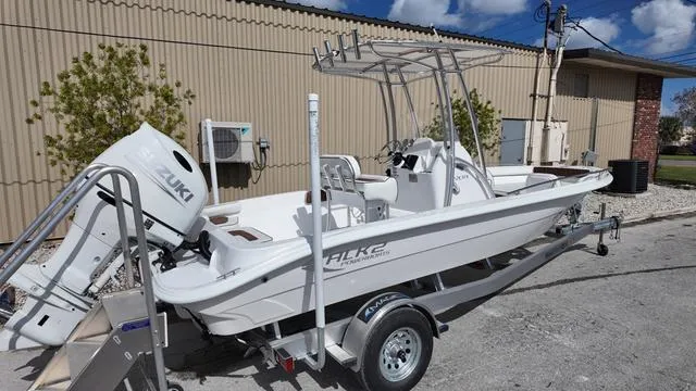 Slide: The Image of 2025 ALK2 22CRX boat on trailer with Suzuki outboard motor, parked outdoors. - 7