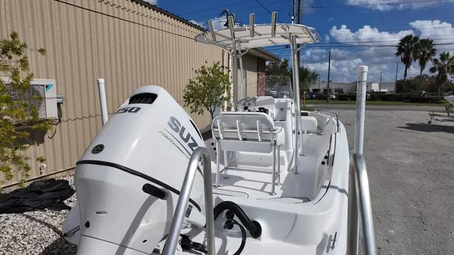 Slide: The Image of White ALK2 22CRX boat with Suzuki engine, parked outdoors, 2025 model. - 8