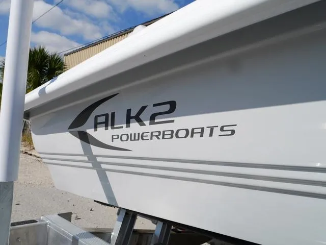 Slide: The Image of ALK2 17HS 2025 powerboat side view with logo in a sunny outdoor setting. - 12