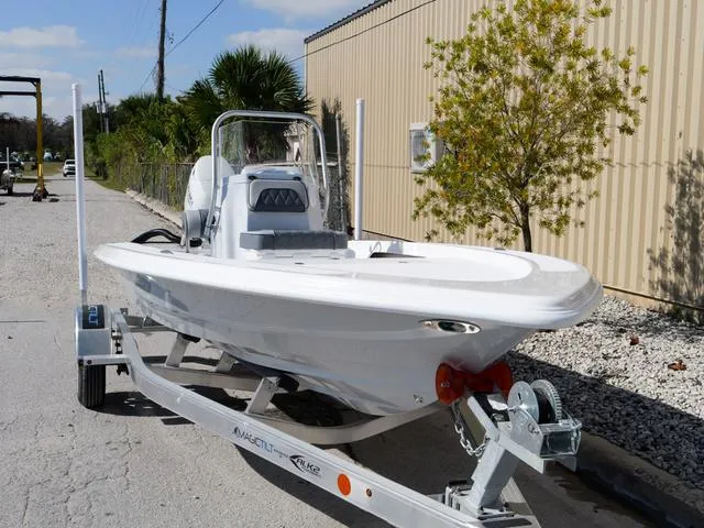Slide: The Image of 2025 ALK2 17HS boat on trailer, parked outdoors near a building. - 14