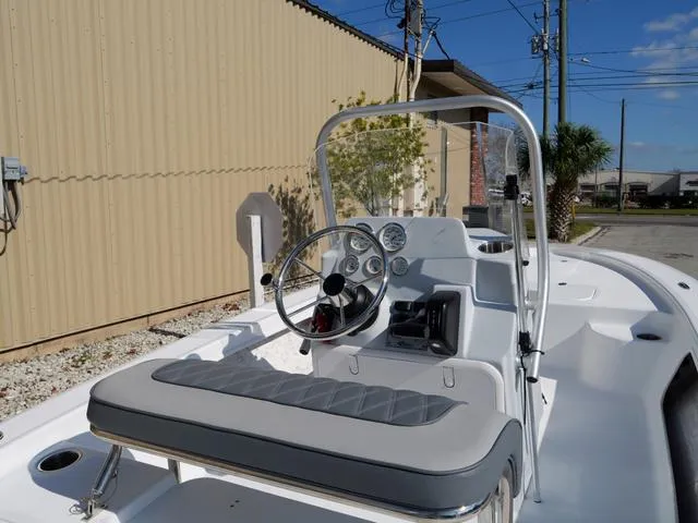 Slide: The Image of Center console of 2025 ALK2 17HS boat with steering wheel and gauges. - 18