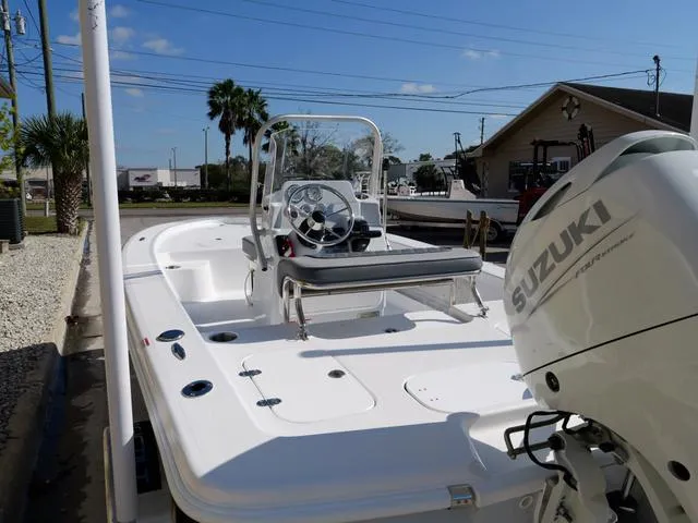 Slide: The Image of White ALK2 17HS boat with Suzuki engine, docked outdoors, clear sky background. - 20