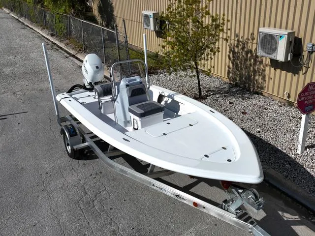 Slide: The Image of 2025 ALK2 17HS boat on trailer, parked outdoors near a building. - 26