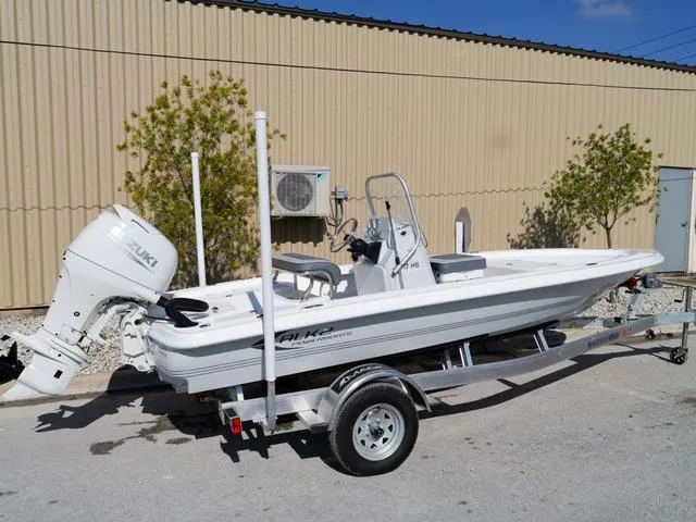 Slide: The Image of 2025 ALK2 17HS boat on trailer, parked outdoors near a beige building. - 3