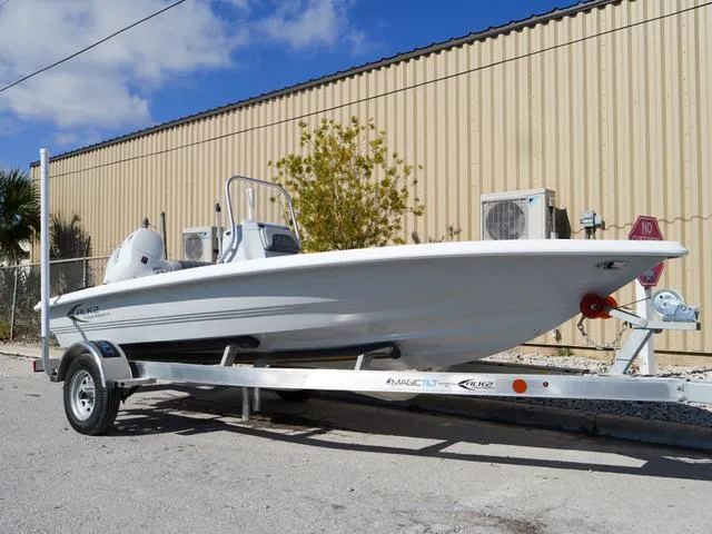 Slide: The Image of 2025 ALK2 17HS boat on trailer, parked near industrial building under blue sky. - 9