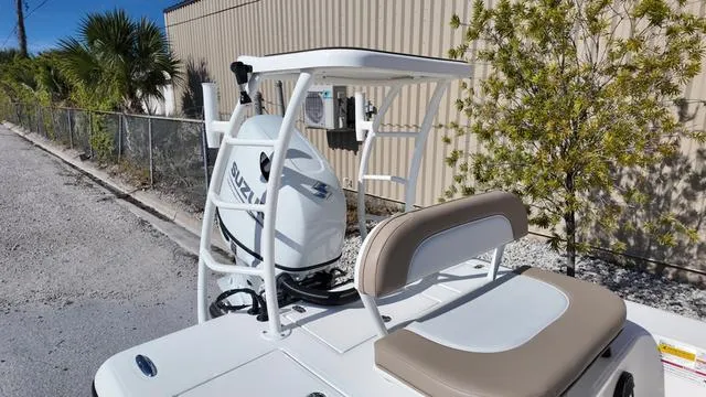 Slide: The Image of 2025 Spyder Boats FX19 Vapor with Suzuki engine, parked outdoors near a fence. - 11