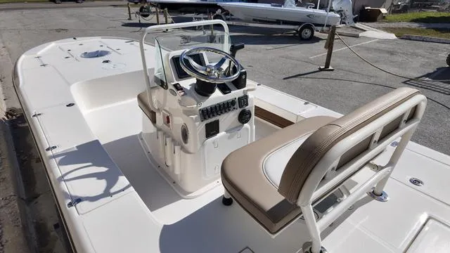 Slide: The Image of 2025 Spyder Boats FX19 Vapor center console with seating and steering wheel. - 12