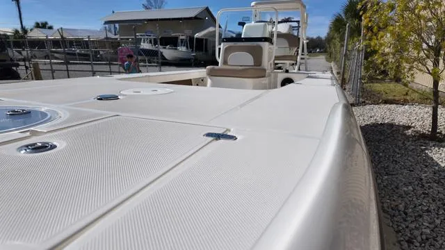 Slide: The Image of 2025 Spyder Boats FX19 Vapor, sleek deck view, parked outdoors. - 15
