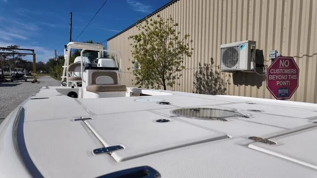 Slide: The Image of 2025 Spyder Boats FX19 Vapor docked near a building with a "No Customers" sign. - 16