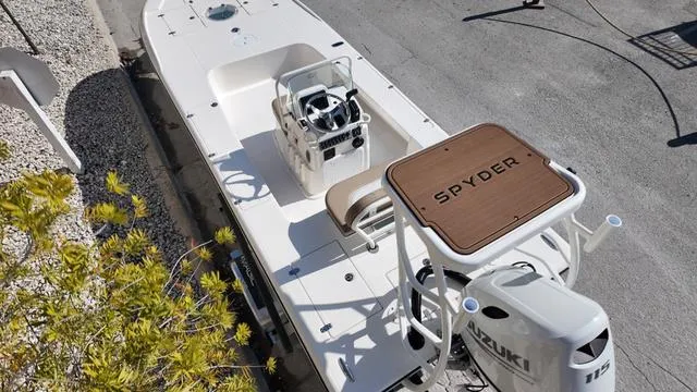 Slide: The Image of 2025 Spyder Boats FX19 Vapor, white deck, Suzuki engine, aerial view. - 21