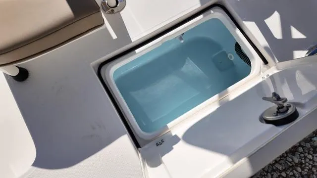 Slide: The Image of 2025 Spyder Boats FX19 Vapor livewell with open lid, showcasing interior design. - 30