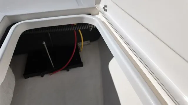 Slide: The Image of Open storage compartment in 2025 Spyder Boats FX19 Vapor, showing wiring and interior details. - 34