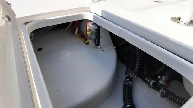 Slide: The Image of 2025 Spyder Boats FX19 Vapor interior wiring and storage compartment. - 35