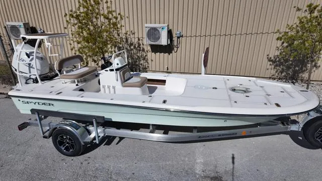 Slide: The Image of 2025 Spyder Boats FX19 Vapor on trailer, sleek design, parked outdoors. - 38