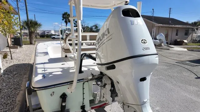 Slide: The Image of 2025 Spyder Boats FX19 Vapor with Suzuki outboard motor, parked outdoors. - 8