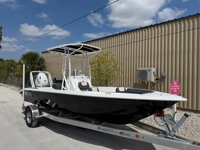 Slide: The Image of 2025 ALK2 22CRS boat on trailer, parked outdoors under blue sky. - 1
