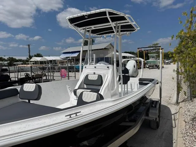 Slide: The Image of 2025 ALK2 22CRS boat with GPS and stereo, docked under a sunny sky. - 11