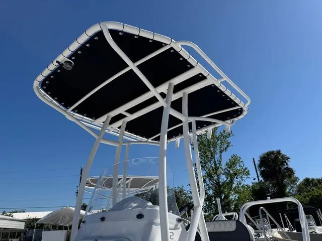 Slide: The Image of T-top canopy on ALK2 22CRS boat, 2025 model, under clear blue sky. - 3