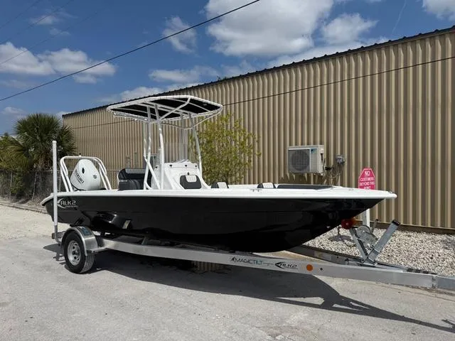 Slide: The Image of 2025 ALK2 22CRS boat on trailer, parked outdoors under blue sky. - 7