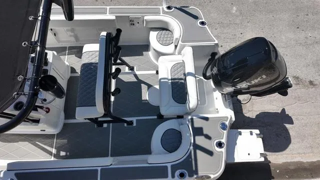 Slide: The Image of 2025 Polar 195 CC boat interior with seating and Suzuki outboard motor. - 12