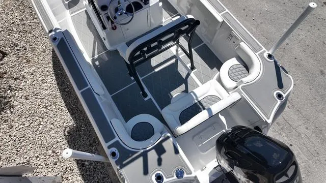 Slide: The Image of 2025 Polar 195 CC boat interior with seating and steering console, viewed from above. - 13