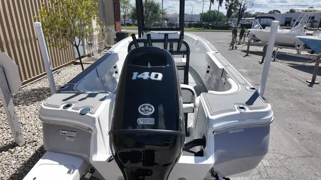 Slide: The Image of 2025 Polar 195 CC boat with 140 HP engine, docked outdoors. - 16