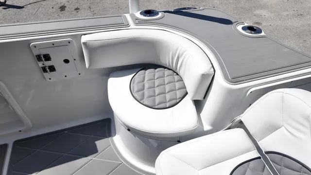 Slide: The Image of 2025 Polar 195 CC boat interior with cushioned seating and cup holders. - 18
