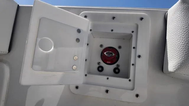 Slide: The Image of 2025 Polar 195 CC boat battery switch compartment with open cover. - 20