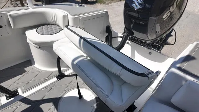 Slide: The Image of 2025 Polar 195 CC boat interior with white seating and Suzuki outboard motor. - 23