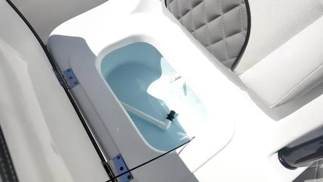Slide: The Image of 2025 Polar 195 CC boat interior storage compartment with white and gray seating. - 29